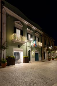 a building with two balconies on the side of it at night at CA' DO' Guest House in Matera