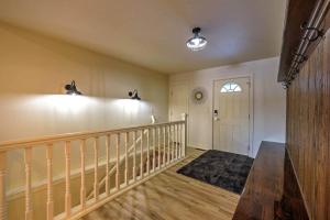 een kamer met een trap en een witte deur met een raam bij Tee Time and Lake Fun at Tagalong in Birchwood