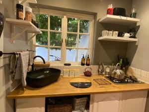 a kitchen with a counter with a black bowl on it at Maggie Rose Cottage Self Catering in Greyton in Greyton