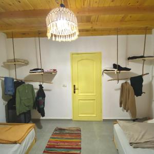a room with a yellow door and a chandelier at Amir House cozy studio in Dahab +13 photos