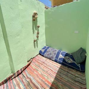 a corner of a room with a green wall at Amir House cozy studio in Dahab