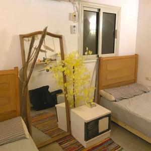 a room with a room with two beds and a mirror at Amir House cozy studio in Dahab