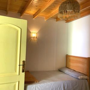 a room with a bed with a light on the wall at Amir House cozy studio in Dahab