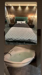 een bad in een slaapkamer met een bed bij B&M Mini jecuzzi Lovers room Self check-in in Vilnius