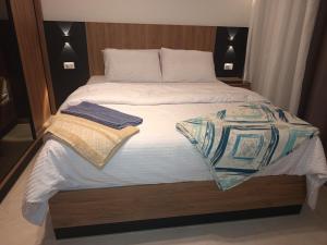 een bed met twee handdoeken erop bij Golf Heights Resort Nabk Bay Sharm El Sheikh One Bedroom Apartment in Sharm El Sheikh +85 foto's