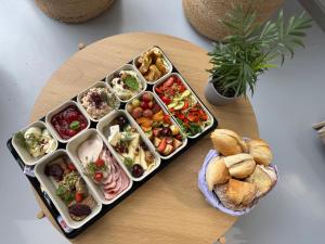 a tray filled with different types of food on a table at Wyjątkowy domek w kompleksie Patyki Las Możliwości in Zelów +23 photos