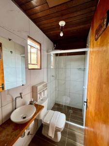 a bathroom with a toilet and a sink and a shower at Casa Moreira´s Chalés in Monte Verde +44 photos