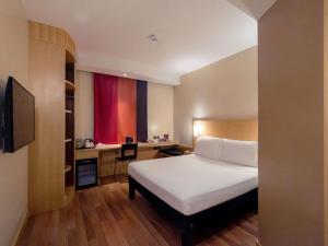 a hotel room with a bed and a desk at Ibis Riyadh Olaya Street in Riyadh