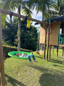 a woman laying on a hammock in a playground at Villa El Colibri in El Peñol