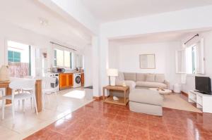 a living room with a couch and a table at Villa Jultomas in Cala en Bosc