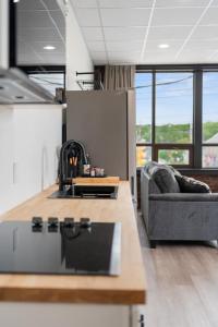 a living room with a couch and a table at Bridge View at The MillRows Suites in New Glasgow
