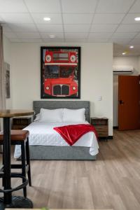 a bedroom with a bed and a picture of a bus at Bridge View at The MillRows Suites in New Glasgow