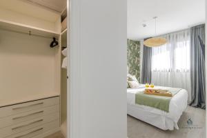 a bedroom with a white bed and a window at Living4malaga Tower Horizon in Málaga +10 photos
