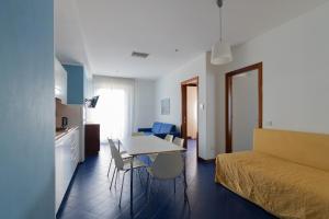 a room with a bed and a table and chairs at Residence Adriatico in Gabicce Mare