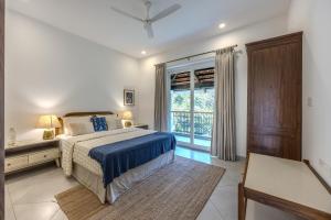 a bedroom with a bed and a window at ELIVAAS Signature Cygnus with Pvt pool in Mapusa