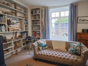a living room with a couch and book shelves at 5B Bridge Street in Lyme Regis