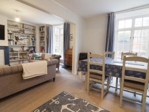 a living room with a table and a couch at 5B Bridge Street in Lyme Regis