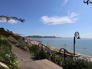 a walkway leading down to a beach with a clock at 5B Bridge Street in Lyme Regis