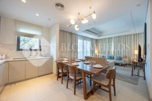 a kitchen and dining room with a table and chairs at Bloomfields 3BR - Address Residences Fujairah in Fujairah +18 photos