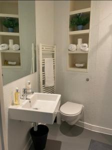 a white bathroom with a sink and a toilet at Birmingham Central NewStreet 1Bed in Birmingham