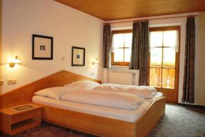 a bedroom with a large bed with a wooden frame at Hotel Residence Rabenstein in Moso