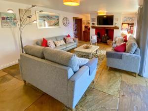 un soggiorno con due divani e una TV di Coombehayes Barn a Uplyme