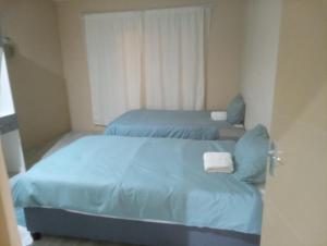 En eller flere senge i et værelse på Infinity Guesthouse