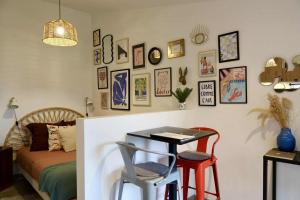 a bedroom with a bed and a table and stools at Le joli jardin face à l'Abbaye in Pont-à-Mousson +20 photos