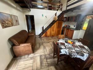 a living room with a table and a couch at Chalé Gran Paraíso Cotijuba in Belém +15 photos