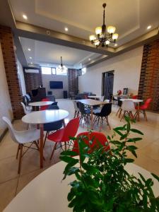 a dining room with tables and chairs and a plant at Cherry Garden Boutique Hotel in Yeghegnadzor