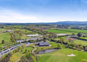 an aerial view of a golf course with a river and a resort at Eden Lodge Retreat in Crosby