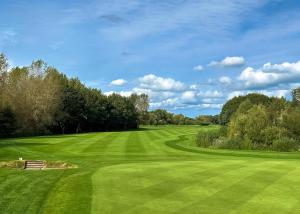 a view of a lush green golf course at Eden Lodge Retreat in Crosby