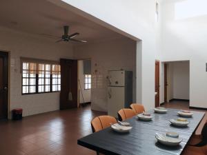 a dining room with a table and chairs and a refrigerator at Sentul KL Private Cozy Bungalow Homestay - Free Parking & Wifi in Kuala Lumpur