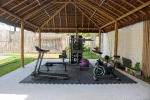 a gym with several exercise equipment in a building at Apartamentos Curimã in Passo de Camarajibe