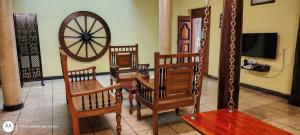 a room with a wooden table and chairs and a wheel at Elite Heritage Stay in Puducherry
