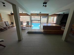 a large room with a swimming pool in a house at Departamento en pleno centro, con Pileta in San Martín de los Andes