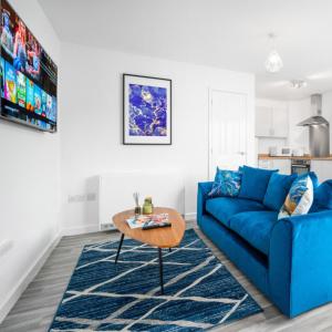 a living room with a blue couch and a table at Modern Two Bed Apartment - Sleeps 3 - Parking - Netflix 50C in Netherton