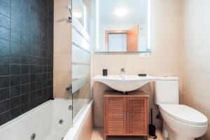 a bathroom with a sink and a toilet and a mirror at Doctor Fleming in Carmona +41 photos