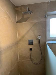 a shower with a shower head in a bathroom at Appartement Wilhelm in Ehrwald