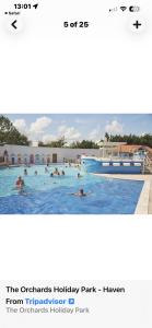 a group of people swimming in a swimming pool at Coastal Beachfront Caravan in Brightlingsea