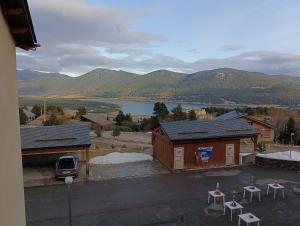 a building with a view of a lake and mountains at Chalets de L Isard D N35 2P6 in Les Angles