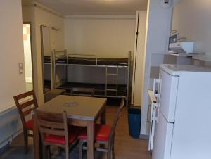a small room with a table and chairs and a bunk bed at Chalets de L Isard D N35 2P6 in Les Angles +4 photos