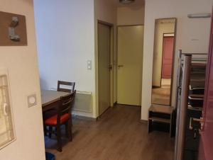 a room with a table and chairs and a hallway at Chalets de L Isard D N35 2P6 in Les Angles