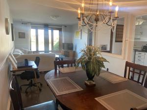 a dining room and living room with a dining table at Napaeno's Place - Home Away from Home in Kingston