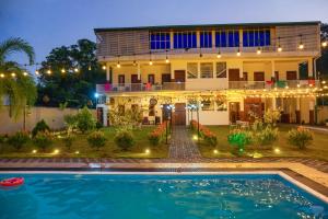 une maison avec une piscine devant dans l'établissement Grand Ranketha Resort, à Kalutara