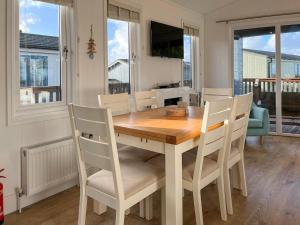 a dining room with a wooden table and chairs at 19 Salcombe Retreat in Salcombe
