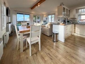 a kitchen and living room with a table and chairs at 19 Salcombe Retreat in Salcombe