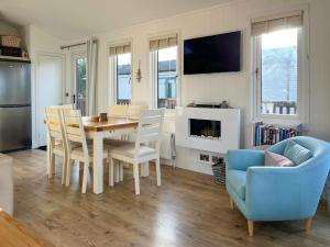 a kitchen and dining room with a table and chairs at 19 Salcombe Retreat in Salcombe