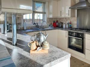 a kitchen with a counter with a tea kettle on it at 19 Salcombe Retreat in Salcombe