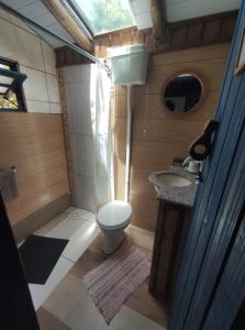 a small bathroom with a toilet and a sink at Atelie Hospedagem in Palhoça